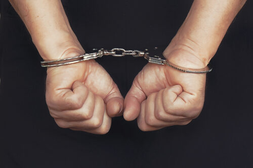 person in handcuffs