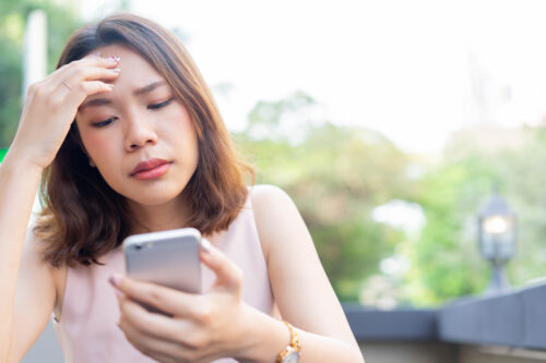 close up young woman reading content or news on social media website with stress feeling for mental health lifestyle concept