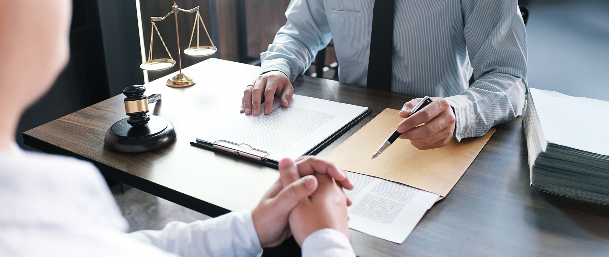 Legal counsel presents to the client a signed contract with gavel and legal law