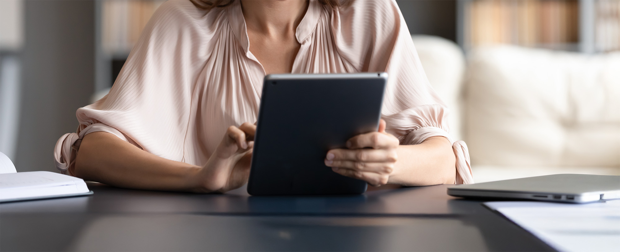 Millennial girl browsing internet on modern tablet