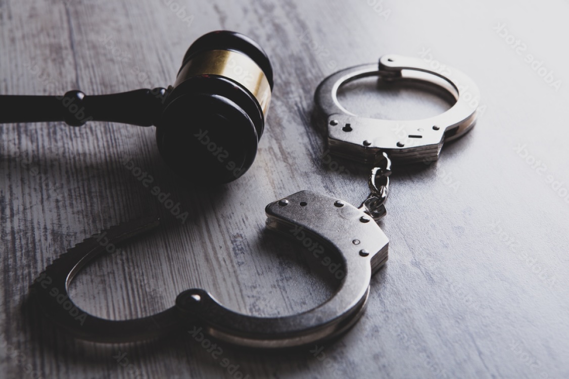 handcuffs and gavel on a table