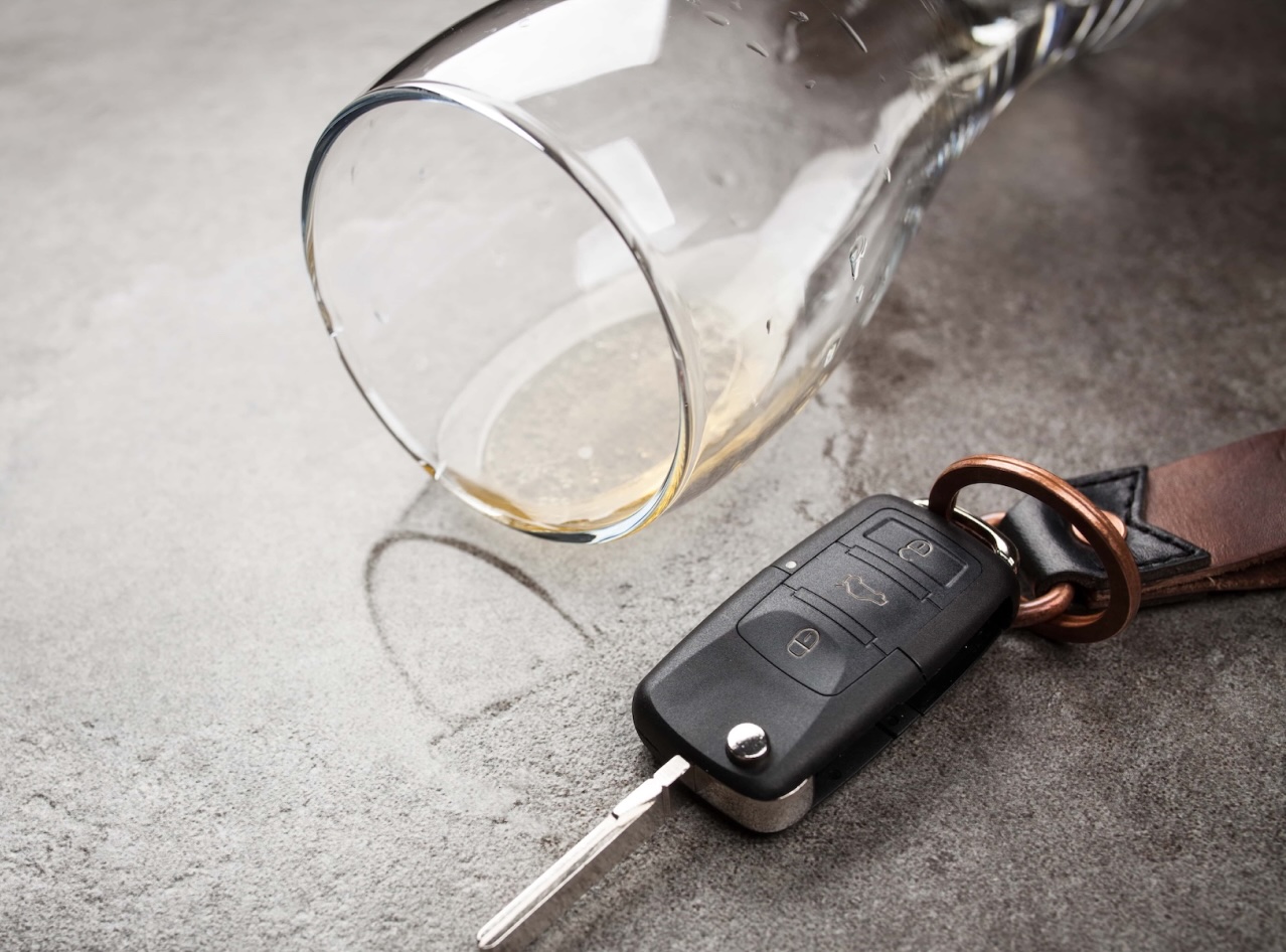 car keys next to spilled alcoholic beverage on table